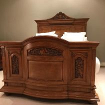 Fine quality carved walnut double bed, late 19th Century, of architectural form with a breakfront