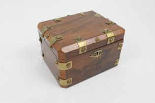 Rosewood and brass mounted tea caddy, canted rectangular form with brass strap embellishment, the