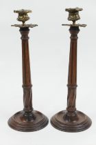 Pair of Georgian style mahogany and cast brass candlesticks, having cast urn shaped sconce over a