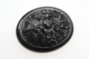 Victorian Whitby jet carved brooch, circa 1900, oval form and carved with a floral bouquet, 70mm x