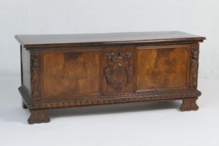 Italian walnut cassone, 19th Century, the hinged top opening to a candle box, the front centred with