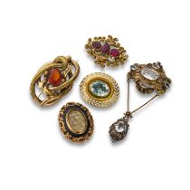 Five Victorian brooches comprising an olive leaf enamelled oval brooch, centred with a pale stone,