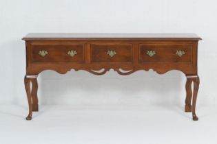 Georgian style walnut low dresser, moulded edge and three drawers with brass handles, raised on