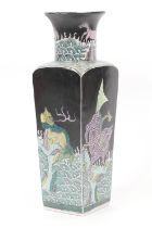 Chinese famille noir vase, square section beneath a trumpet neck, decorated with mythical beasts,
