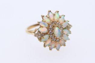 Opal and diamond cluster ring, of flowerhead design set with fifteen oval cabochon opals dispersed