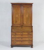 Oak and inlaid bureau bookcase, the top with a moulded cornice over two moulded panel doors inlaid