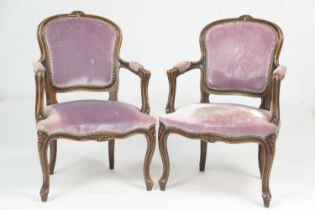Pair of French style walnut fauteuils, upholstered throughout in faded lilac fabric, with pad