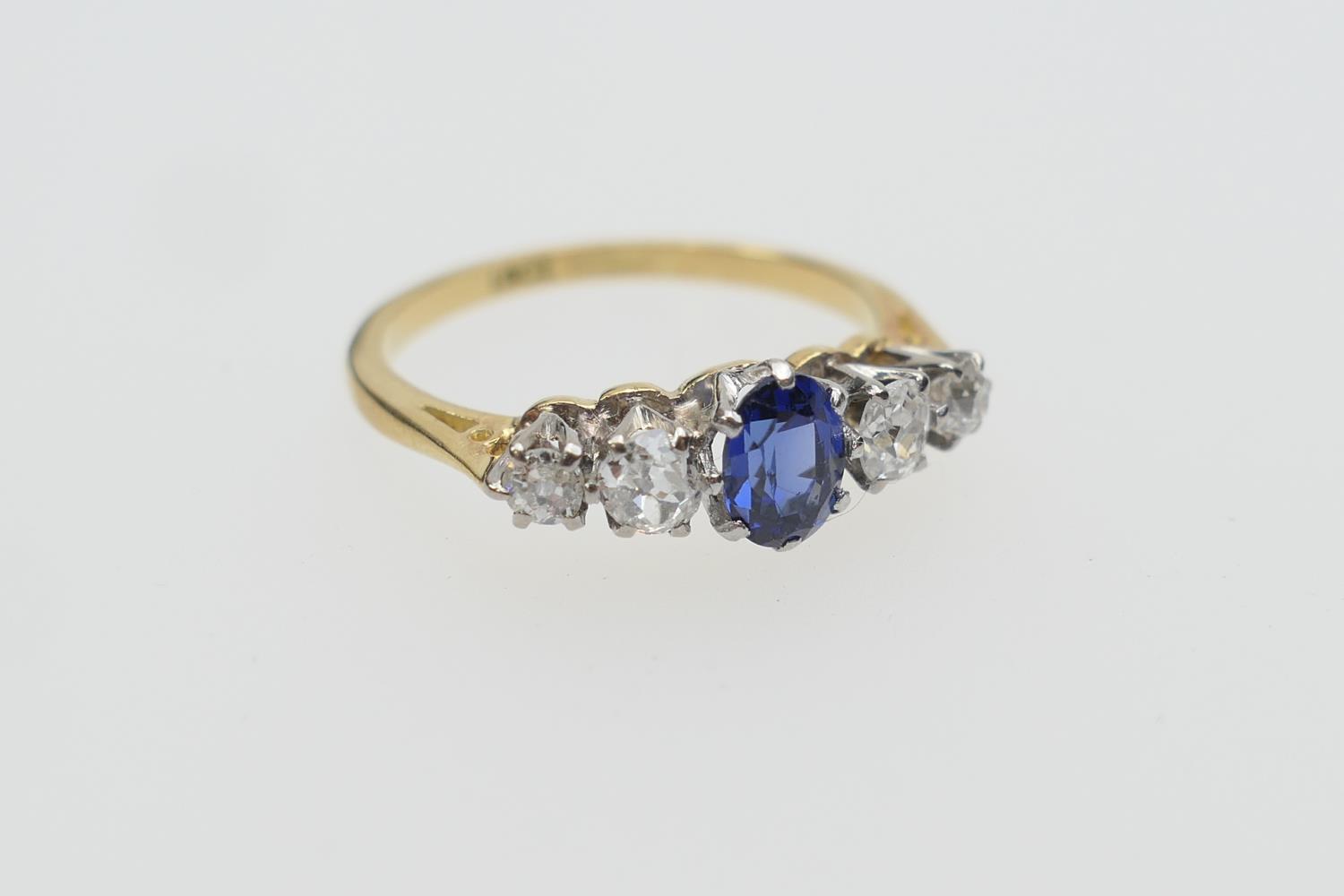 Sapphire and diamond five stone ring, centred with an oval cut sapphire of approx. 0.5ct flanked