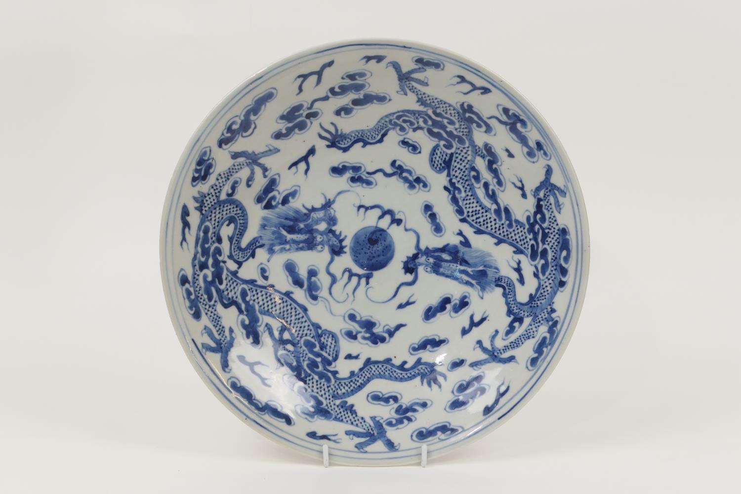 Chinese blue and white plate, early 20th Century, decorated with dragons chasing a central flaming