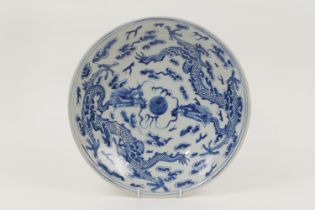 Chinese blue and white plate, early 20th Century, decorated with dragons chasing a central flaming