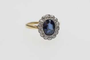 Sapphire and diamond cluster ring, the oval sapphire of approx. 1ct bordered with fourteen small