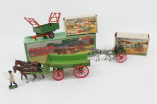 Britains farm accessories comprising a farmer with two horse cart, boxed; two wheel tipping