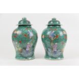 Pair of Chinese green glazed lidded jars, 19th Century, decorated with boys picking pomegranates