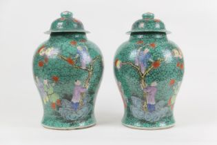Pair of Chinese green glazed lidded jars, 19th Century, decorated with boys picking pomegranates