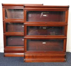 Two Globe Wernicke mahogany three section bookcases, each with up and over glazed doors, on an