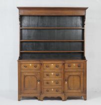 North Wales oak enclosed dresser and plate rack, early 19th Century, with a moulded cornice over