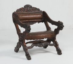 Italian carved walnut Savonarola style armchair, with embossed leather pad back and seat,