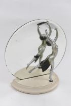 Art Deco figural mirror, having a silvered finish spelter dancing figure, in the style of Lorenzl,