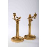 A pair of candlesticks with candle lifting and tightening system