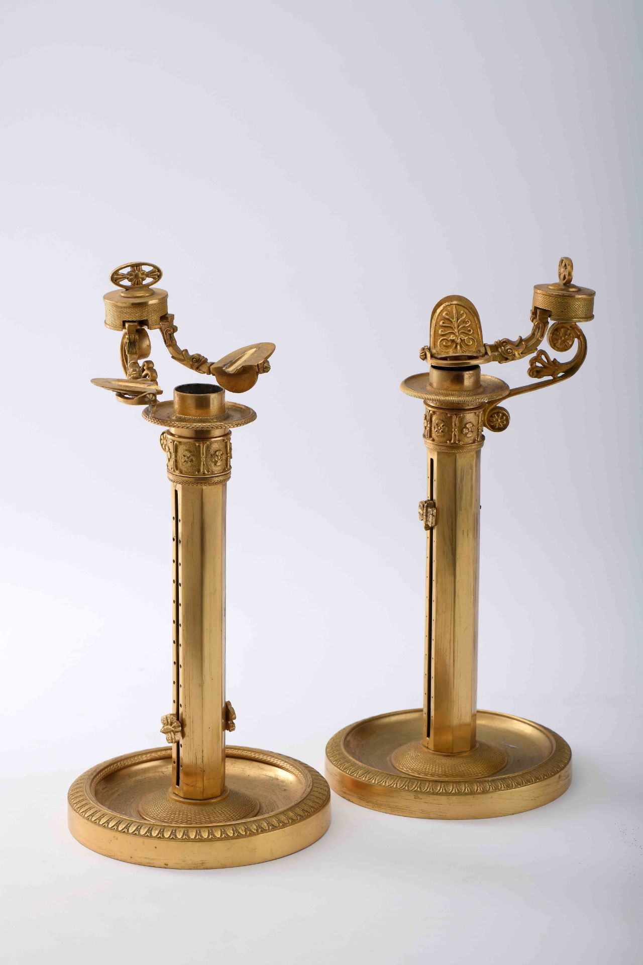 A pair of candlesticks with candle lifting and tightening system