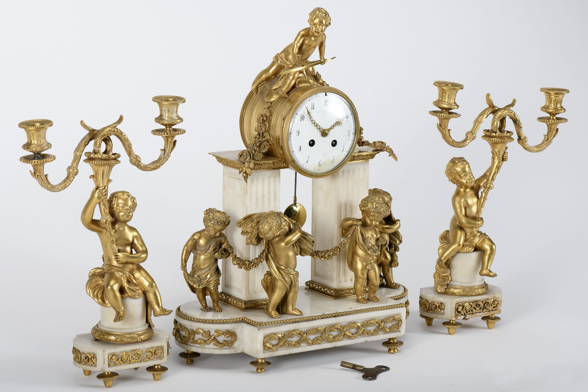 A Garniture - Clock and pair of two-light candelabra