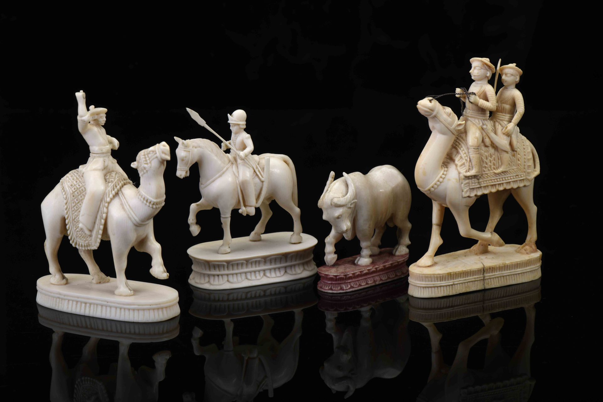 Chess Pieces - Two on a camel, one on horseback and a bull