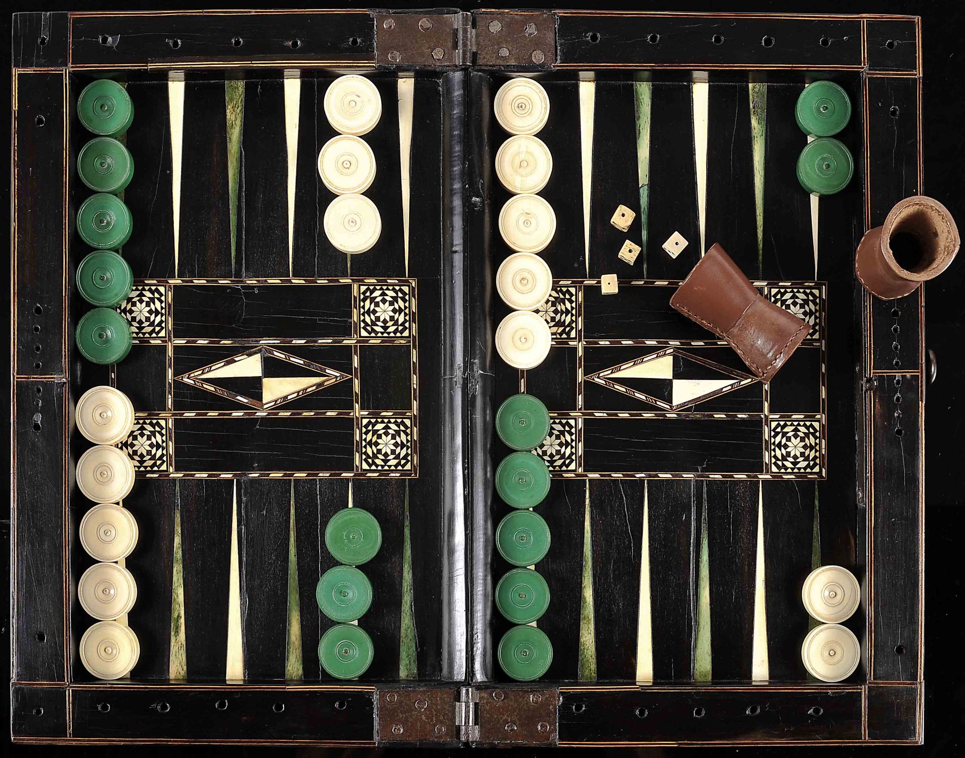 Articulated chess and backgammon board closed in the shape of a box with backgammon pieces