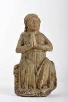 A Saint seated with hands in a praying position