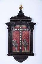 A reliquary cross inside hanging display cabinet