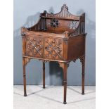 A Mahogany Bedside Cabinet of "Georgian" Design, with shaped and fretted back, fitted cupboard