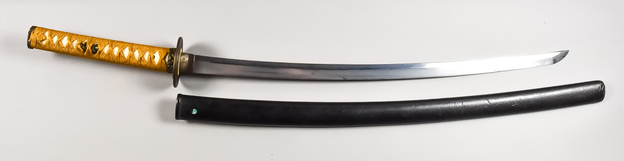 A Japanese Katana, signed 'Kane Kage', 24ins blade with visible cloud hamon, cotton wrapped hilt,