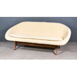A 1960s Lurashell Black Fibreglass and Wood Settee, upholstered in cream cloth, and on curved