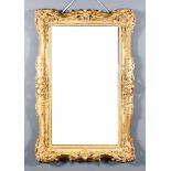 A Late 19th Century Gilt Rectangular Wall Mirror, with ornately carved frame, with trailing leaf,