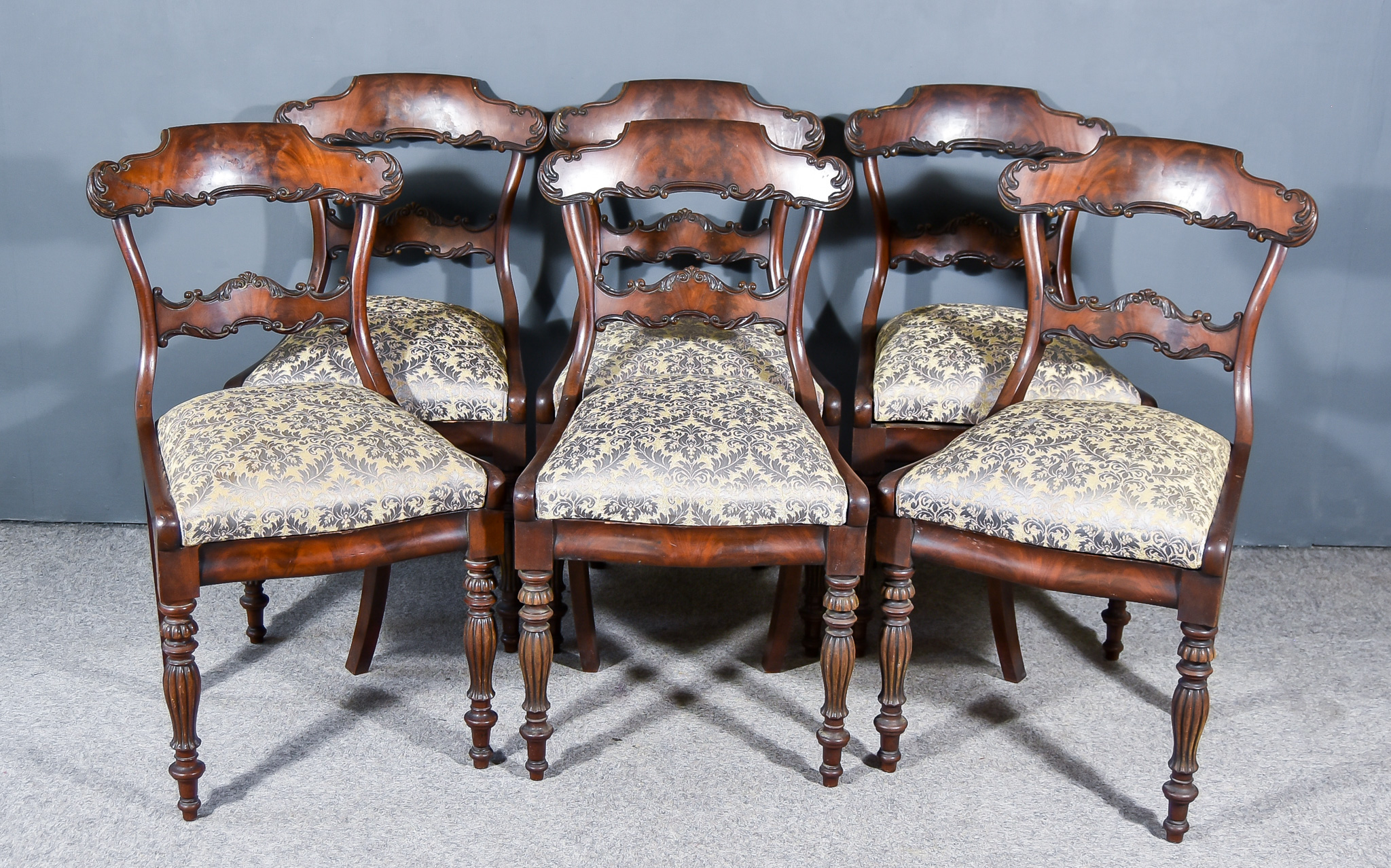 A Set of Six Early Victorian Mahogany Dining Chairs, the shaped crest rails and splats with scroll