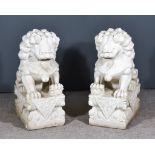 A Pair of Reconstituted Stone Carvings of Seated Kylin, on rectangular plinth bases, 30ins high