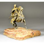 A Cast Figure of a Middle Eastern Gentleman Astride a Stallion, mounted on a piece of natural stone,