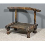 A Late 19th/Early 20th Century West African Hardwood "Baule"Chair, with chip carved curved crest