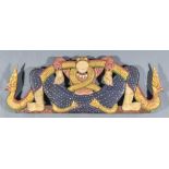 An Eastern Carved Polychrome and Giltwood Wall Plaque, carved as an entwined figure and dragon 36ins