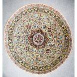 An Early 20th Century Part-Silk Tabriz Circular Carpet, woven in colours of ivory, navy blue and
