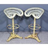 A Pair of Cast Iron Barstools, 20th Century, adapted from tractor seats, the seats with cast