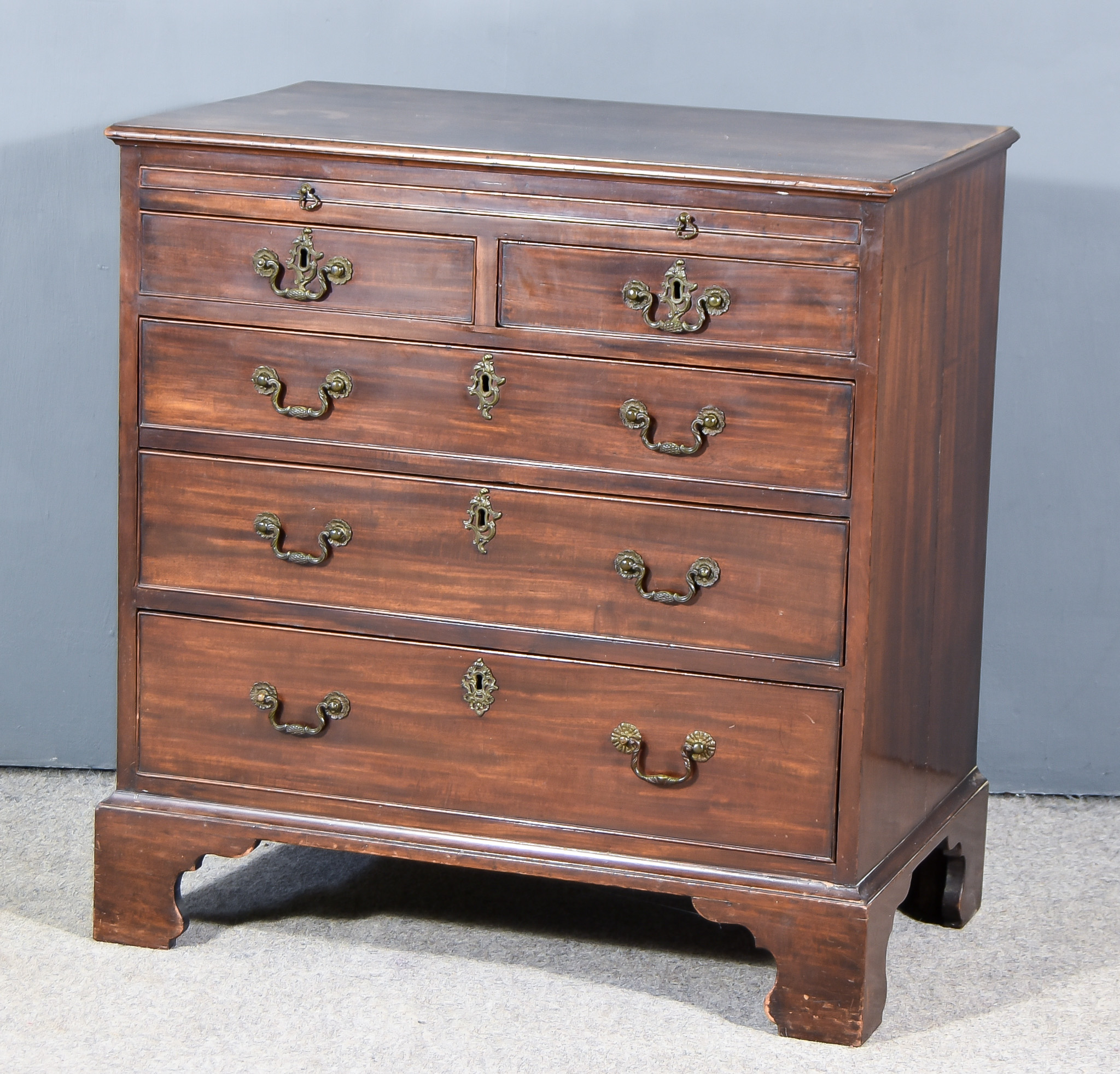 A Mahogany Chest of "Georgian" Design, moulded edge to top, fitted brushing slide, two short and