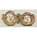 Two Early 20th Century Painted Lead Winged Putti Wall Plaques, each 9.5ins wide x 9ins high
