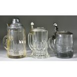 Three World War II German Lidded Glass Drinking Steins, comprising - one 7ins x 3.5ins with pewter