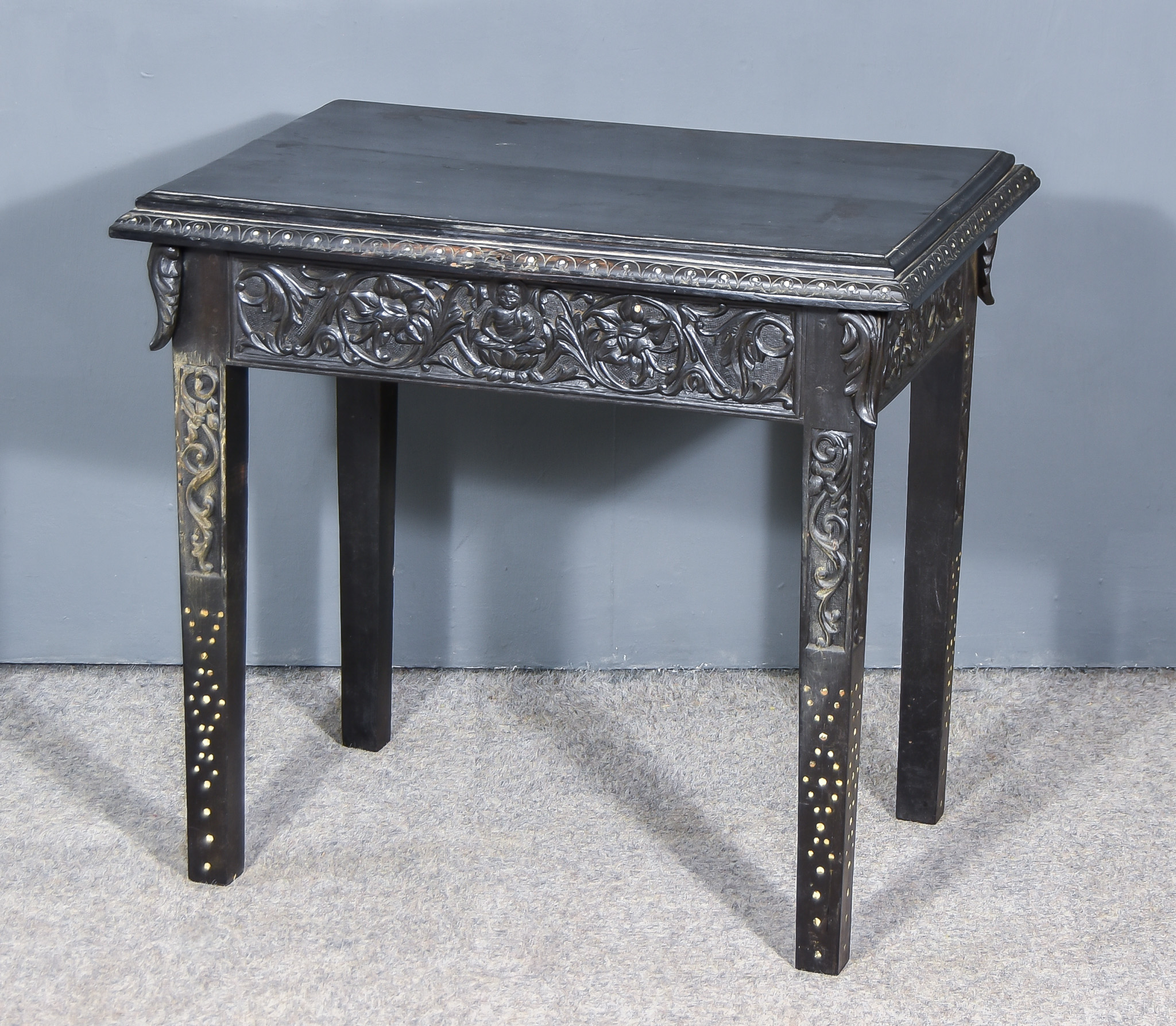 A 19th Century Ebonised Rectangular Occasional Table, with carved frieze, on square tapered legs