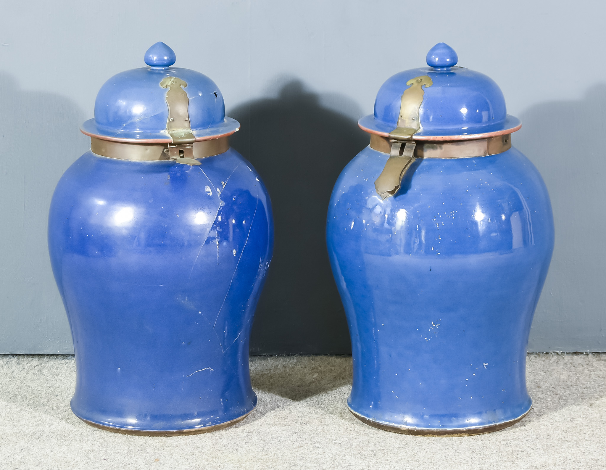 A Pair of Chinese Blue Glazed Porcelain Baluster-Shaped Vases and Covers, with oxidised metal hasp