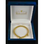 An 18ct Gold Twisted Bracelet, by Wellendorff, with suspended Wellendorff charm, 190mm overall,