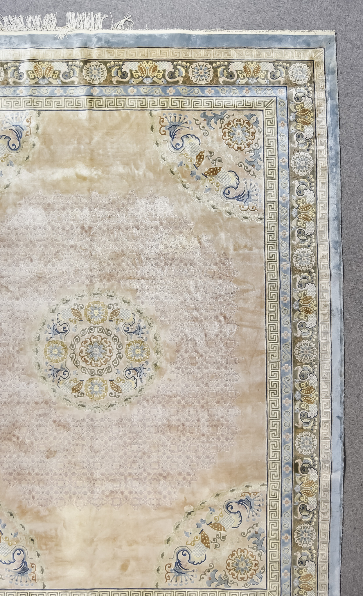 A Modern Part-Silk Carpet of Chinese Design, woven in pastel shades with a central medallion made up