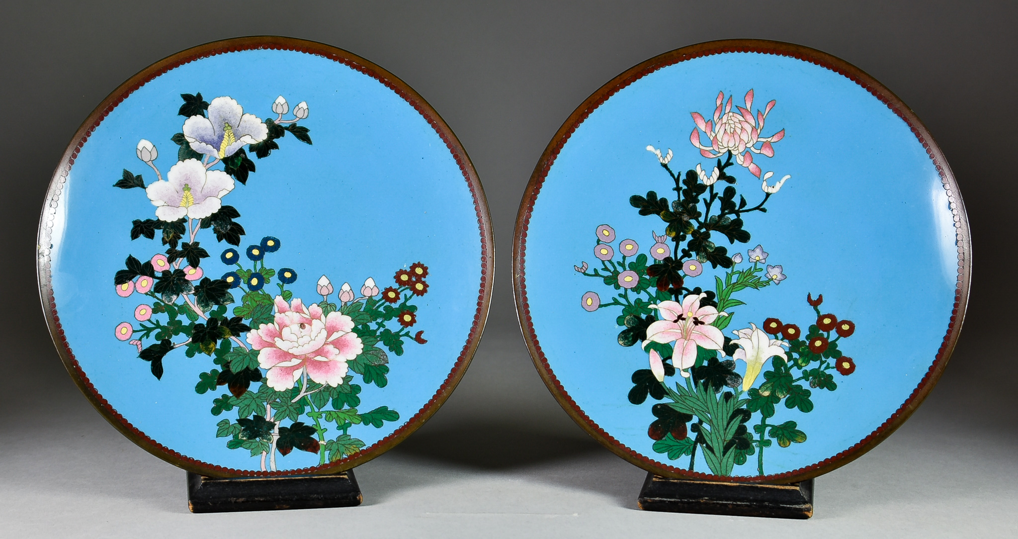 A Pair of Japanese Cloisonné Enamel Circular Dishes, decorated with mixed floral sprays on a