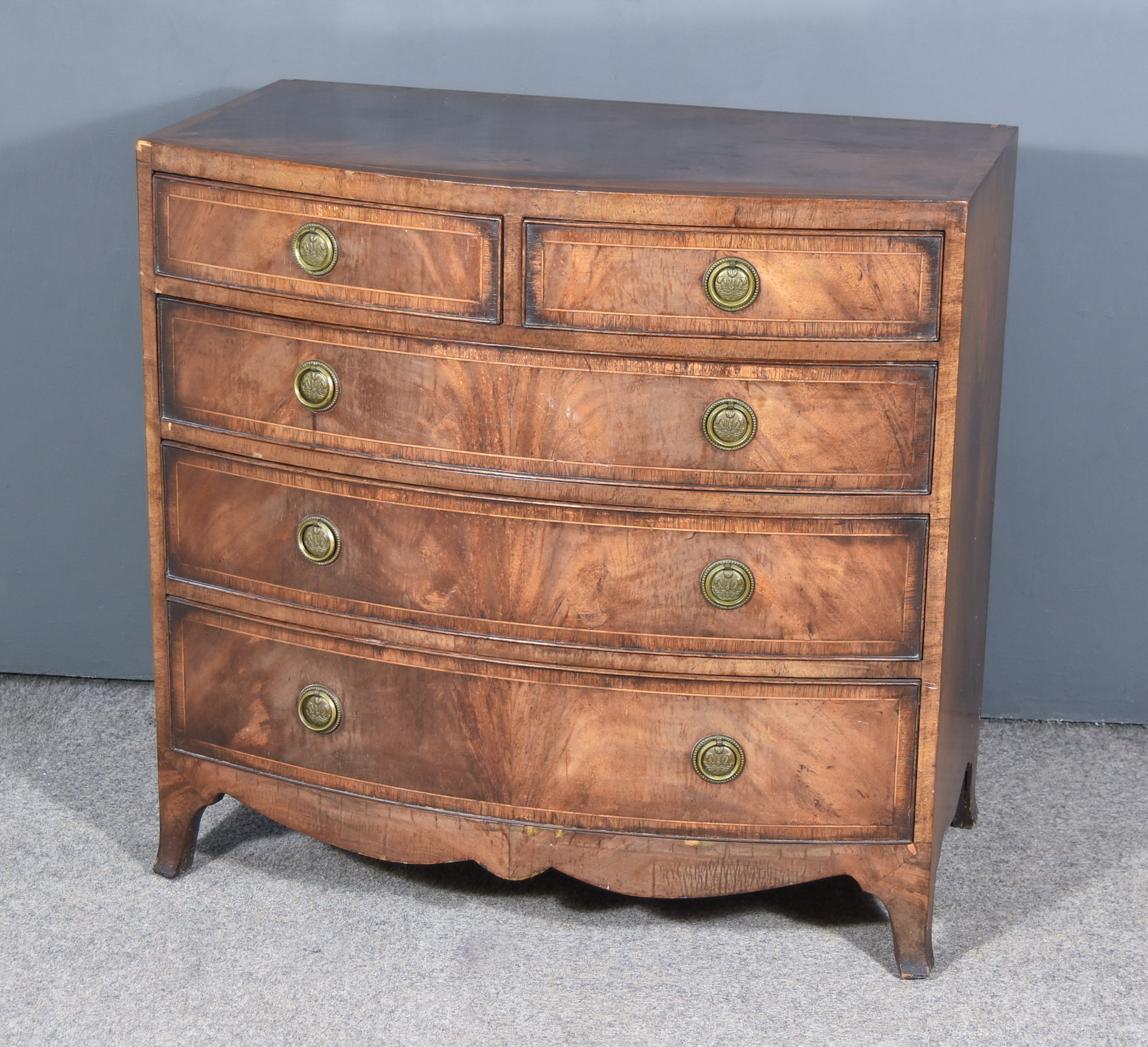 A Mahogany Bow Front Chest of Georgian Design, inlaid with stringings and cross bandings, with