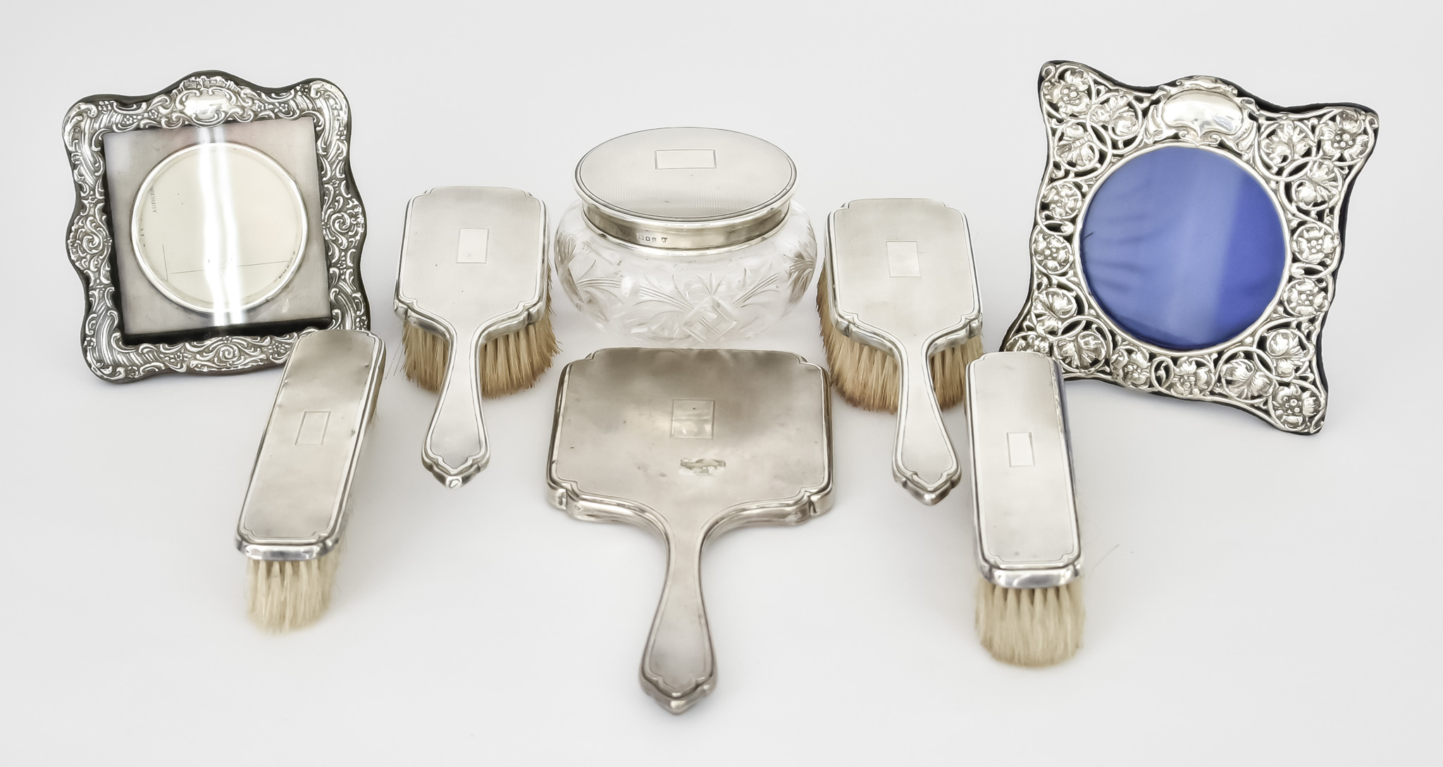 A Victorian Silver Backed Seven-Piece Dressing Table Set and Two Edward VII Silver Photograph